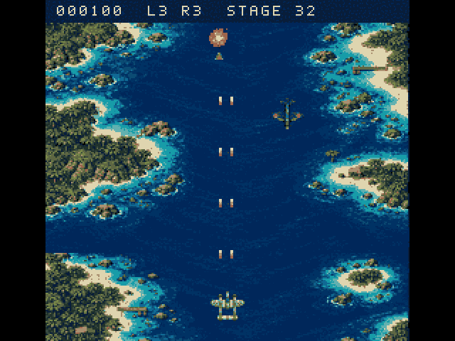 1942 full screen: a strip of dark blue sea between green islands with sandy beaches and reefs. A grey twin-boom fighter at the bottom fires pairs of shots upward toward three dark green enemy planes, one of them bursting. The top line reads 000100, L3 R3, Stage 32.