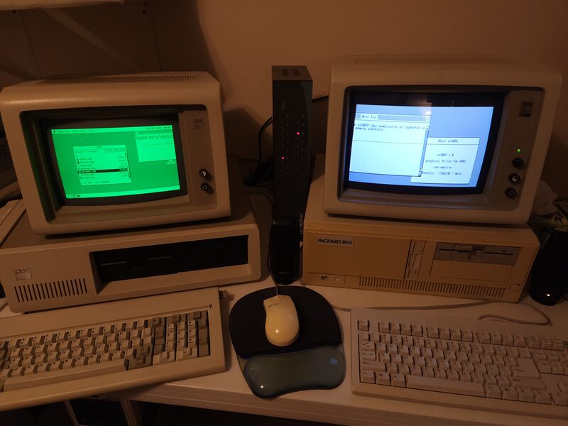Two period PC monitors side by side on a desk, a green monochrome one on the left and a colour one on the right, both showing parts of the same os8088 desktop.