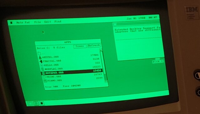 Close-up of the green monochrome monitor: the os8088 menu bar across the top, a file listing in the middle, the dock along the bottom, and at the top right a window cut off at the edge of the screen.