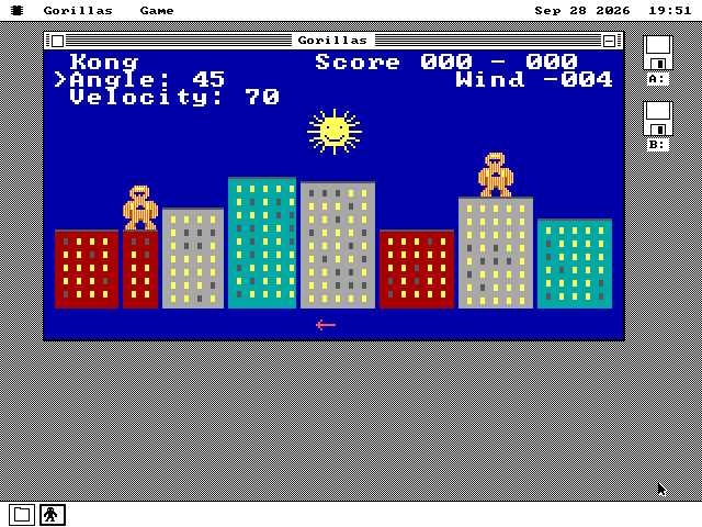 The Gorillas window on the desktop with a match in progress: Kong, Score 000 - 000, Angle 45, Velocity 70 and Wind -004 at the top, the sun, a skyline of red, grey and teal buildings with a gorilla on each side, and a red arrow under the city pointing left.